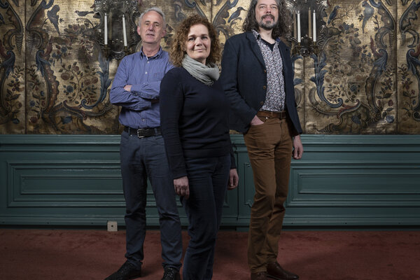 Manon Borst (voor), Adrie Warmenhoven (linksachter) en Josse Pietersma (rechtsachter) voor een gedecoreerde wand in het Planetarium.